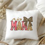 Pink and gold glitter MAMA text on a pillow with leopard bow and hearts.