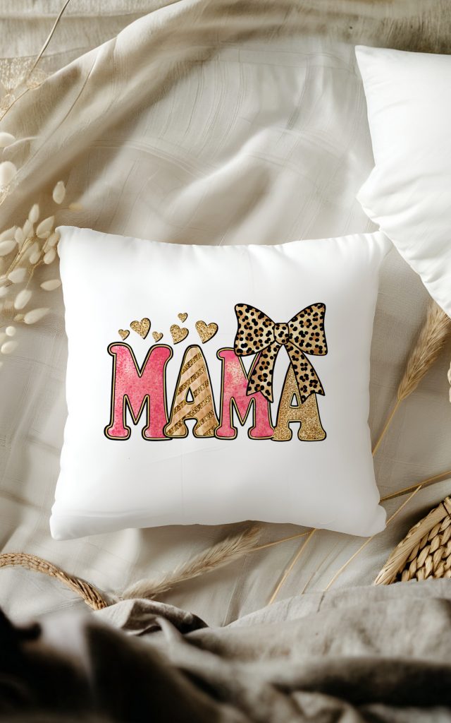 Pink and gold glitter MAMA text on a pillow with leopard bow and hearts.