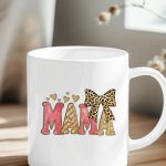 Pink and gold glitter MAMA text on a mug with leopard bow.