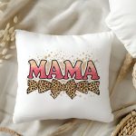 Pink glitter MAMA text on a pillow with leopard bows and splatter design.