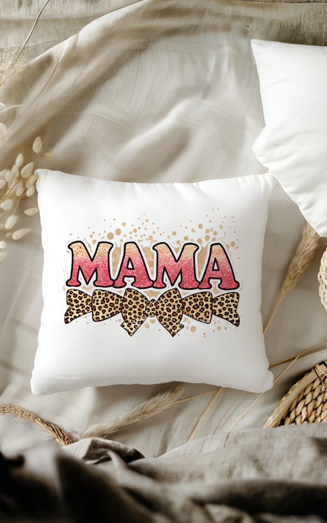 Pink glitter MAMA text on a pillow with leopard bows and splatter design.