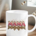 Pink glitter MAMA text on a mug with leopard bows.