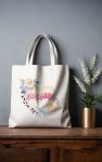 Tote bag mockup with a watercolor design of 'Mama' in pink script on a pastel heart, surrounded by roses and leopard print